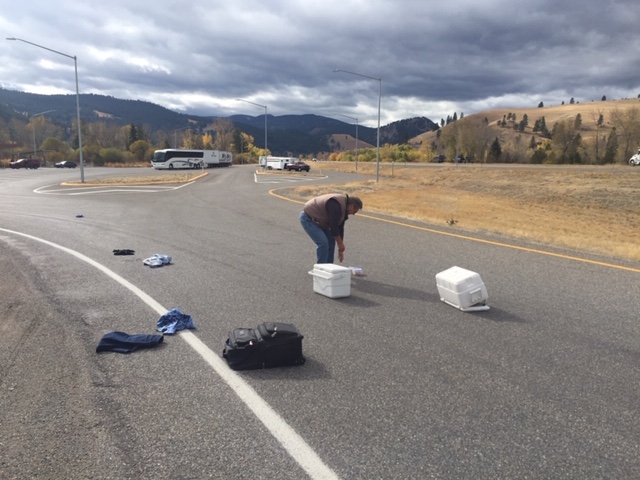 Scattered luggage on freeway ramp