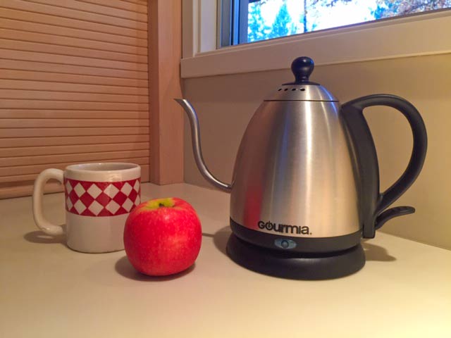 Teapot on my counter with cup and apple for decoration