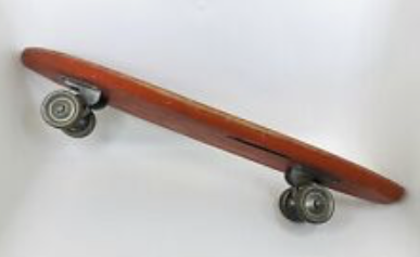 Underside of vintage skateboard with metal wheels.